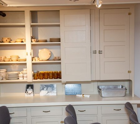 a kitchen with white cabinets and a white countertop