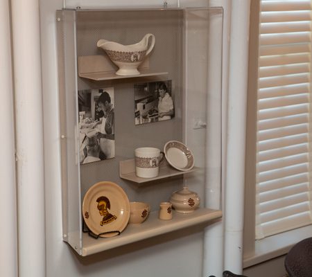a shelf with plates and dishes on it