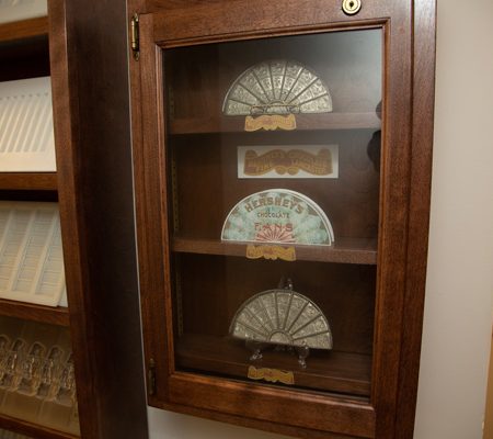 a wooden cabinet with a glass case