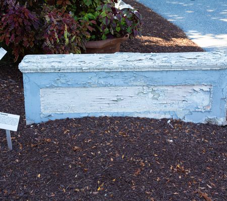 a blue stone wall with white paint