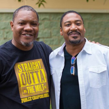 a couple of men standing together