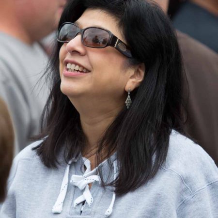 a person wearing sunglasses and smiling