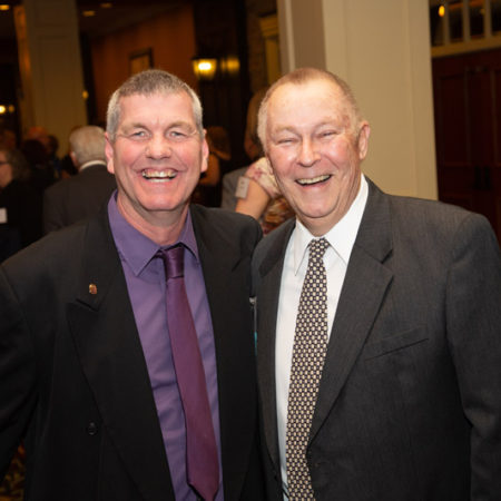 a couple of men smiling