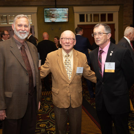 a group of men standing in a room