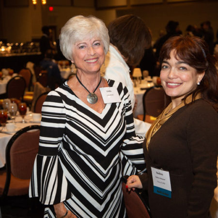 a couple of women at a dinner