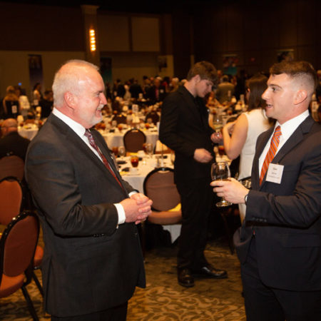 a group of men in suits talking