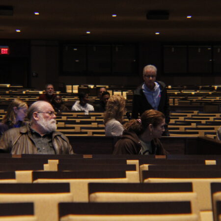 a group of people in a lecture hall