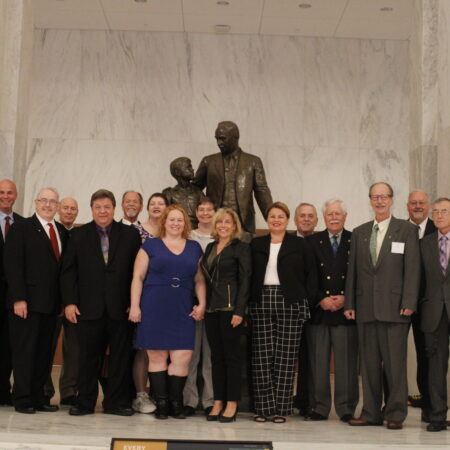 a group of people standing in front of a statue