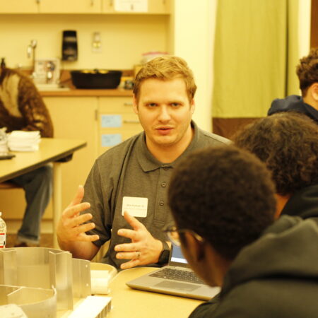 a person talking to a group of people