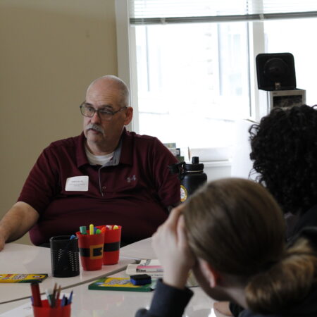 a person sitting at a table with other people
