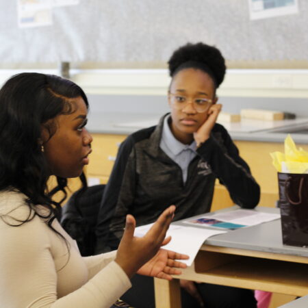 a person talking to a student