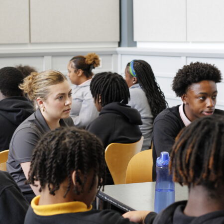a group of people sitting in a classroom