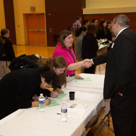 a person shaking hands with a group of people