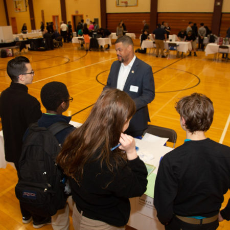 a person standing in front of a group of people
