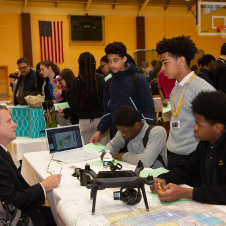 a group of people at a table with a drone