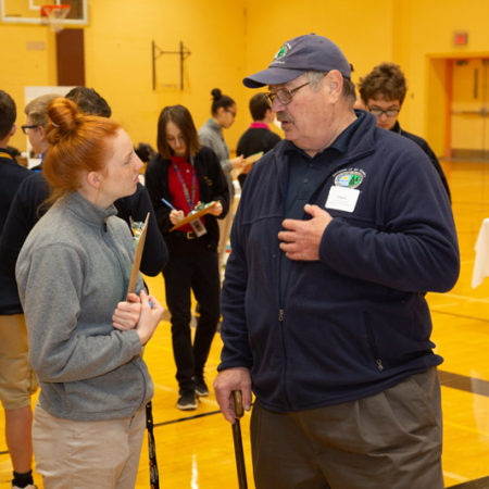 a person talking to a person in a gym