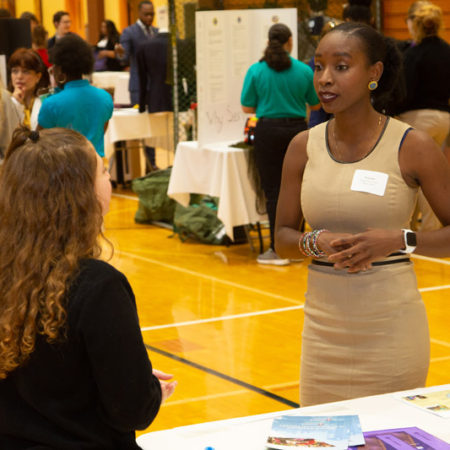a person talking to a person at a table