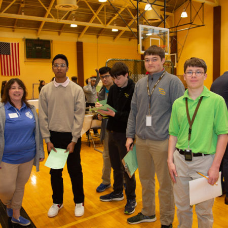 a group of people standing in a gym