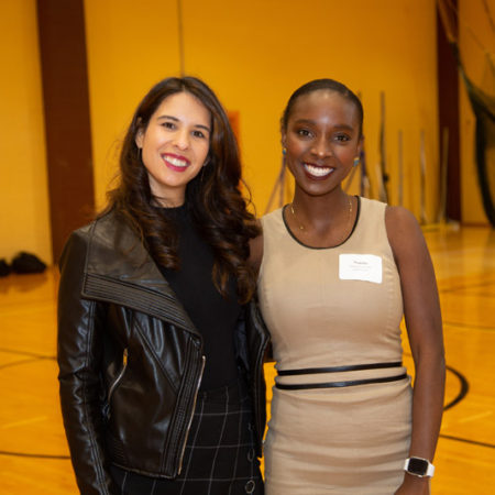 a couple of women standing together