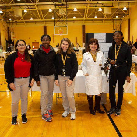 a group of people standing in a gym