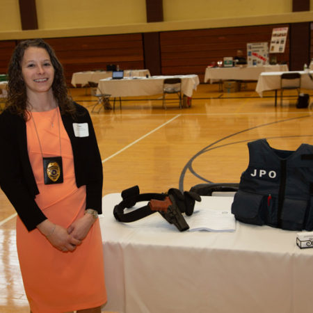a person standing next to a table with a gun