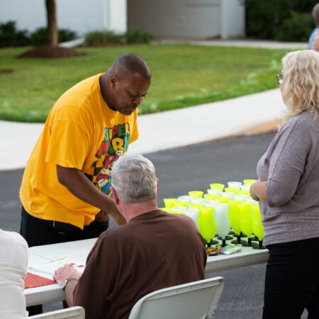 a person standing at a table with a table full of drinks