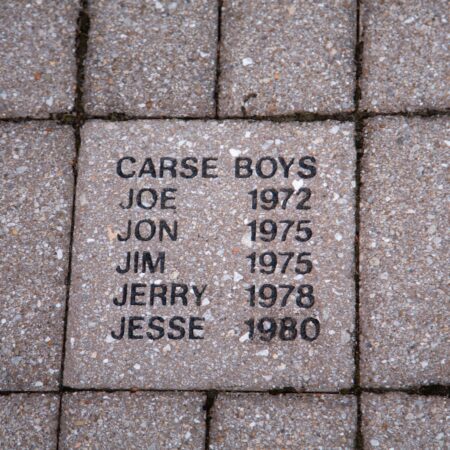 a stone plaque with names on it