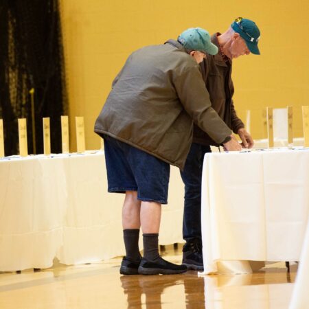 a couple of men standing at a table