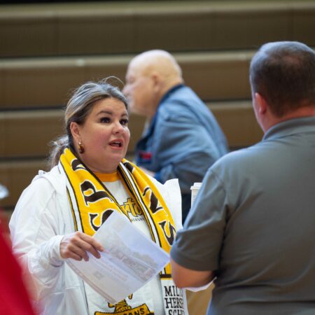 a person holding a yellow scarf