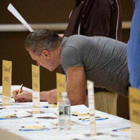 a person writing on papers on a table