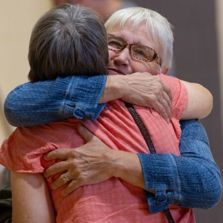 a person hugging another person