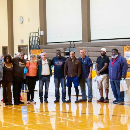 a group of people standing in a gym
