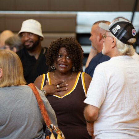 a person in a tank top and a person in a hat