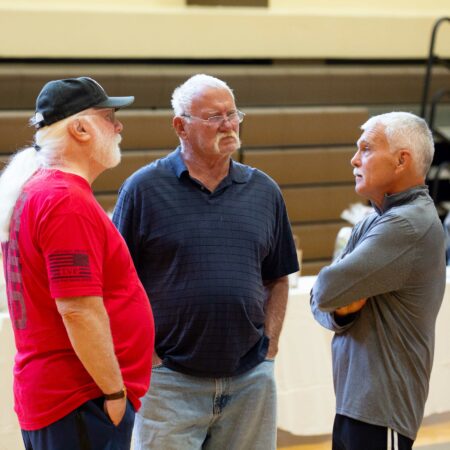 a group of men standing in a gym