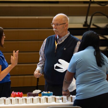 a person standing in front of a table with food