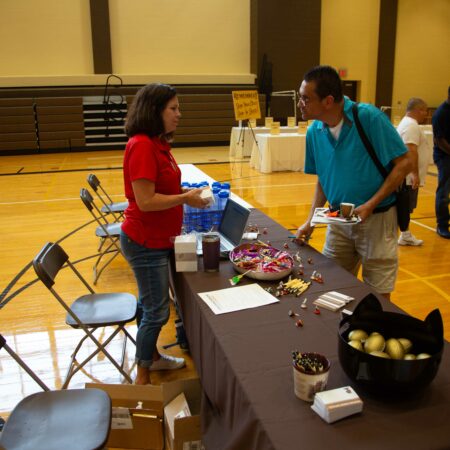 people standing next to a table