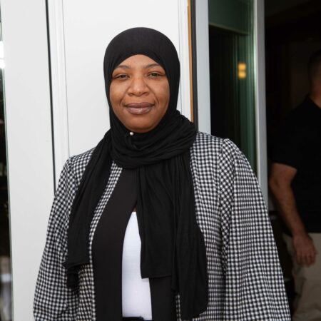 a person wearing a black scarf and a black jacket