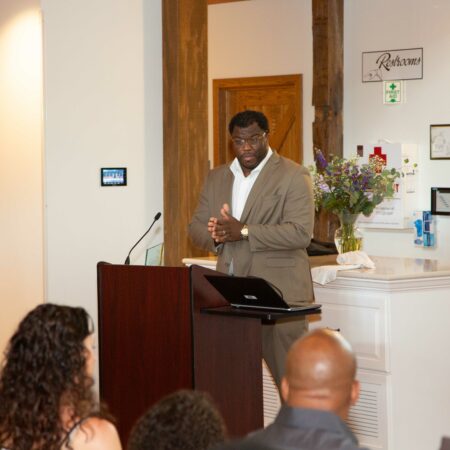 a person standing at a podium giving a presentation