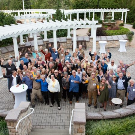 a group of people standing in a garden