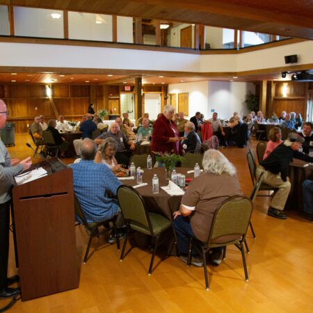 a group of people sitting at tables in a room