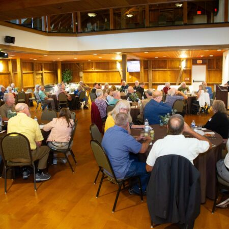a group of people sitting in chairs in a room