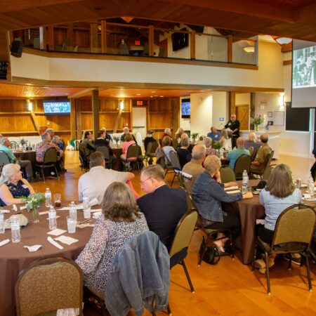 a group of people sitting at tables in a room