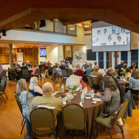 a group of people sitting at tables in a room