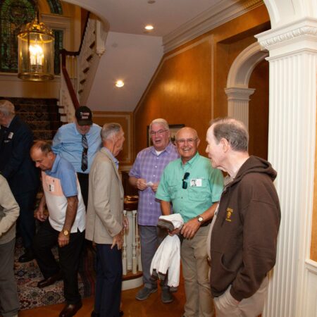 a group of men standing in a hallway