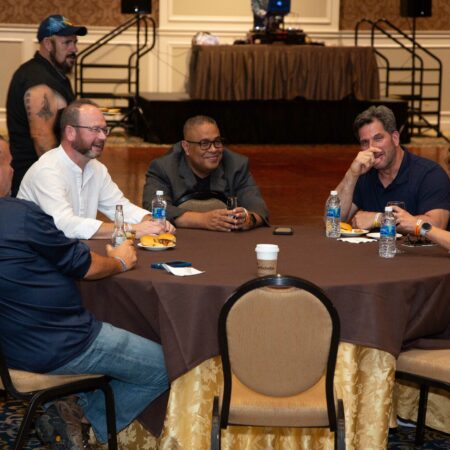 a group of men sitting around a round table