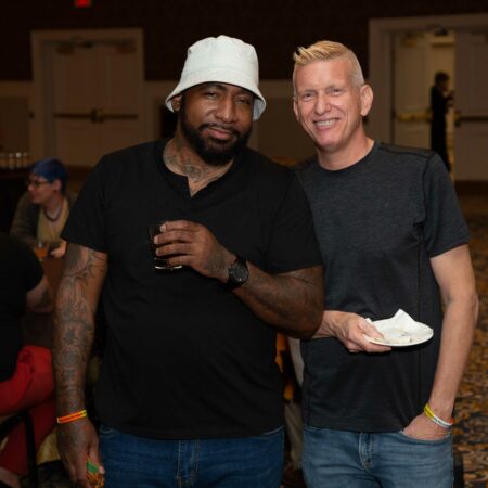 two men standing together smiling