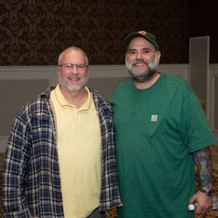 a couple of men standing together