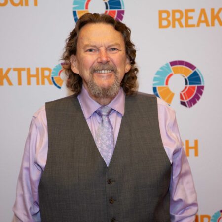 a person in a vest smiling