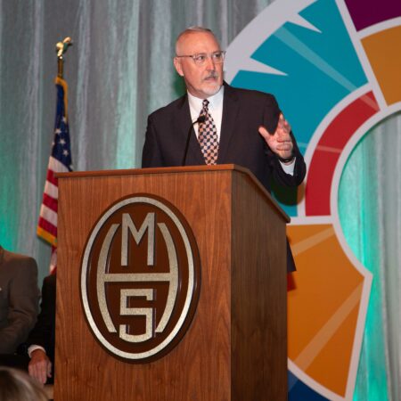 a person standing at a podium