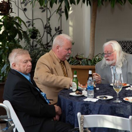 a group of men sitting at a table